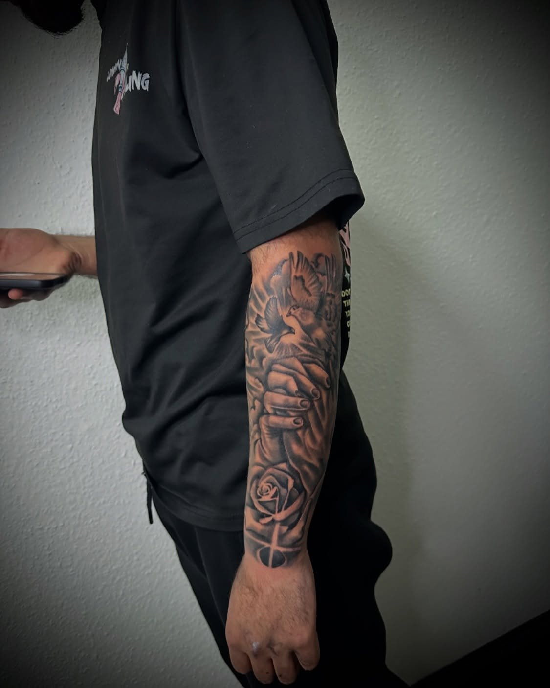 Cross with rays forearm tattoo